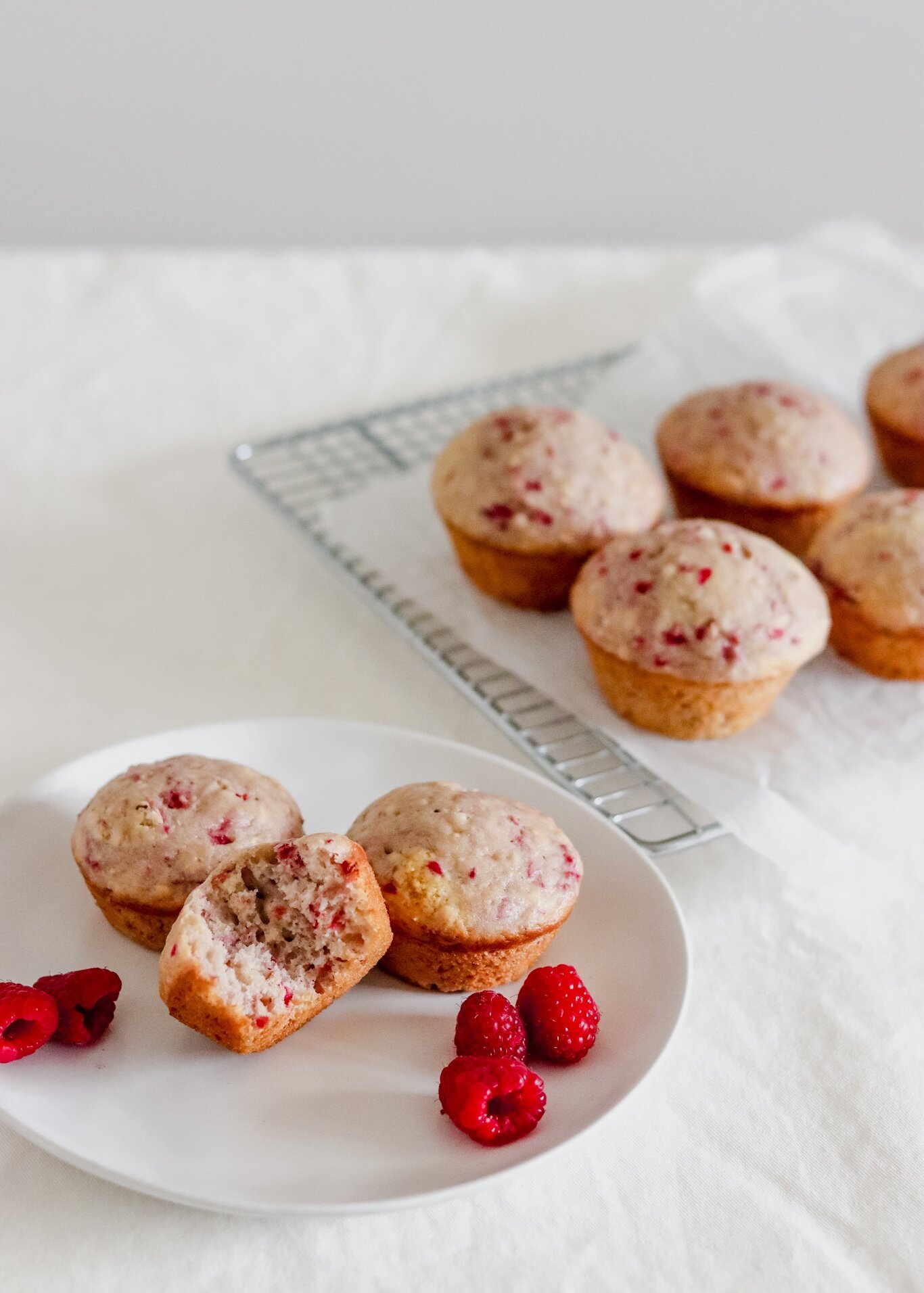 raspberry and almond muffins on a white table