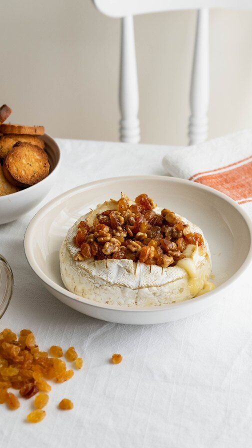(full recipe below) This easy baked brie recipe is the perfect balance of creamy, sweet, and spicy. Made with golden California Raisins, walnuts, honey, and a touch of heat. I've partnered up with @raisins.ca for this show-stopping appetizer.I always keep a stash of California Raisins in my pantry. They’re incredibly versatile! Not just for baking but for adding subtle sweetness to savory dishes like this one. They're also a healthy snack option! They have no added sugar, high in fiber and potassium, and heart-healthy.RECIPE: Baked Brie with Golden Raisins & Honey RecipeIngredients1 wheel of brie (8 oz)½ cup golden California Raisins¼ cup chopped walnuts3 tbsp honey½ tsp red pepper flakesPinch of salt & black pepperInstructionsPreheat oven to 350°F. Line a baking sheet with parchment paper.Score top of brie and bake for 20 mins.In a small saucepan, combine raisins, walnuts, honey, red pepper flakes, salt, and pepper. Simmer on low for 5 minutes.Remove brie from oven, spoon topping over, and serve immediately with crackers or crostini.#CaliforniaRaisins #appetizer #bakedbrie #briecheese #easyappetizers #feelgoodfood #easyrecipe #reels